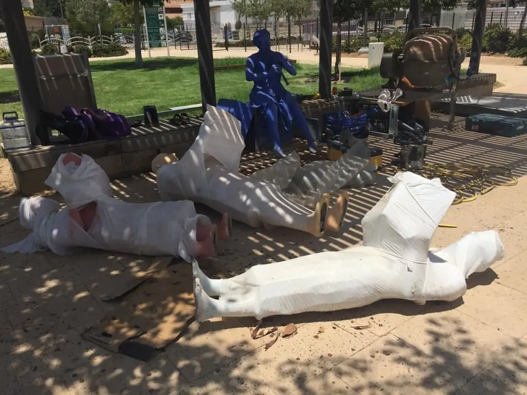 Statues wrapped in protective film in a park