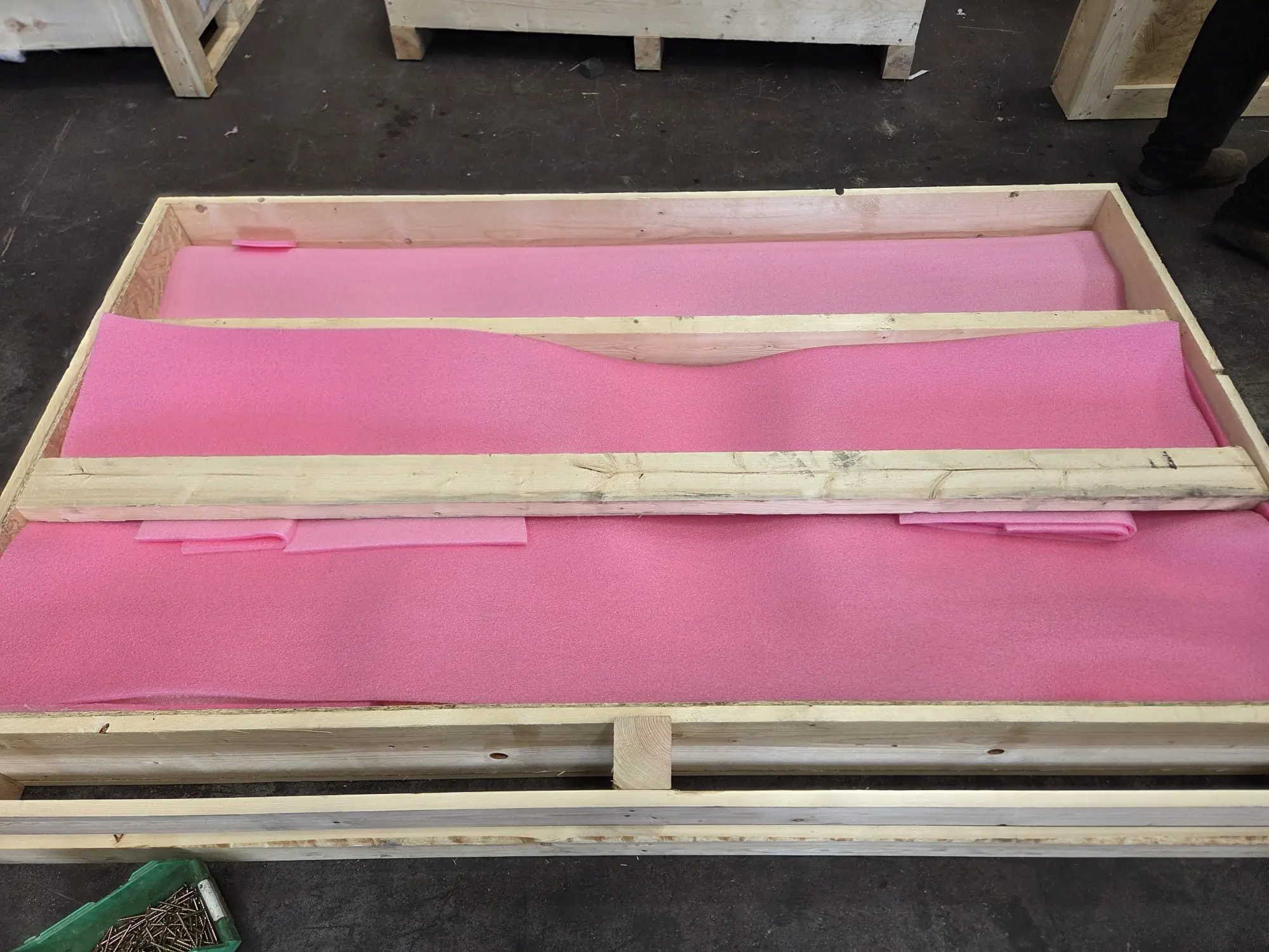 An open custom crate lined with pink protective foam